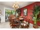 Cozy dining area with wood table, chandelier, and access to the outdoor patio at 2208 Mcmahon Ct # 1033, Orlando, FL 32812