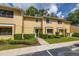 Townhouse exterior with a green front door, manicured shrubs, and a well-maintained lawn at 2208 Mcmahon Ct # 1033, Orlando, FL 32812
