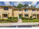 Charming townhouse with manicured landscaping, a green front door, and ample natural light at 2208 Mcmahon Ct # 1033, Orlando, FL 32812