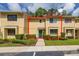 Charming townhouse with manicured landscaping, a green front door, and ample natural light at 2208 Mcmahon Ct # 1033, Orlando, FL 32812