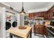 Well-lit kitchen features granite countertops, stainless steel appliances, and laundry at 2208 Mcmahon Ct # 1033, Orlando, FL 32812