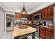 Well-lit kitchen features granite countertops, stainless steel appliances, and functional island at 2208 Mcmahon Ct # 1033, Orlando, FL 32812