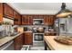 Well-lit kitchen features granite countertops, stainless steel appliances, and functional island at 2208 Mcmahon Ct # 1033, Orlando, FL 32812