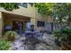 A secluded patio area with comfortable seating, lush greenery, and ample shade at 2208 Mcmahon Ct # 1033, Orlando, FL 32812