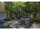 An intimate patio space surrounded by lush greenery and centered around a water fountain at 2208 Mcmahon Ct # 1033, Orlando, FL 32812