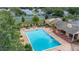 Aerial view of the community pool, clubhouse, and tennis courts surrounded by lush greenery at 2208 Mcmahon Ct # 1033, Orlando, FL 32812