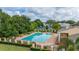A sunny pool area offering lounge chairs, tables, and a view of the surrounding community at 2208 Mcmahon Ct # 1033, Orlando, FL 32812