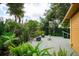 Relaxing backyard deck surrounded by tropical plants and lush greenery, perfect for outdoor entertaining and enjoying nature at 2320 E Crystal Lake Ave, Orlando, FL 32806