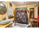Vintage bathroom with a clawfoot tub, patterned shower curtain, and classic fixtures at 2320 E Crystal Lake Ave, Orlando, FL 32806