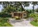Charming cottage-style home with a screened porch and a brick driveway, surrounded by lush landscaping at 2320 E Crystal Lake Ave, Orlando, FL 32806