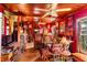 Expansive living area with red walls, wood ceilings, and eclectic collection of vintage decor at 2320 E Crystal Lake Ave, Orlando, FL 32806
