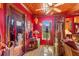 Unique living room with red walls, wooden ceiling, and eclectic decor; lots of light from the window at 2320 E Crystal Lake Ave, Orlando, FL 32806