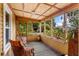 Inviting screened-in porch with wicker furniture, wood ceilings, and decorative accents at 2320 E Crystal Lake Ave, Orlando, FL 32806