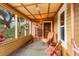 Inviting screened-in porch with wicker furniture, wood ceilings, and decorative accents at 2320 E Crystal Lake Ave, Orlando, FL 32806