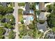 An aerial view shows the home has a large rectangular pool and spacious yard with mature landscaping at 2350 Derbyshire Rd, Maitland, FL 32751