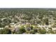 Overhead shot of a suburban neighborhood showcasing houses, lush trees, streets, and a mix of roof styles at 2350 Derbyshire Rd, Maitland, FL 32751