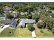 Aerial view of a single-story home with a pool, showcasing its layout within a verdant and suburban neighborhood at 2350 Derbyshire Rd, Maitland, FL 32751