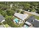 Overhead perspective of the property highlighting the backyard pool and mature trees in a quiet residential neighborhood at 2350 Derbyshire Rd, Maitland, FL 32751