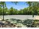 Well-maintained community basketball court surrounded by mature trees and green space at 2350 Derbyshire Rd, Maitland, FL 32751