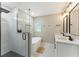 Modern bathroom with a glass shower, soaking tub, and dual vanity sinks at 2350 Derbyshire Rd, Maitland, FL 32751