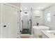 Modern bathroom featuring glass shower, soaking tub, and stylish black and white tile at 2350 Derbyshire Rd, Maitland, FL 32751
