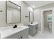 Dual sink bathroom with modern fixtures, framed mirrors and grey shaker cabinets at 2350 Derbyshire Rd, Maitland, FL 32751