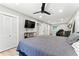 Generous bedroom space includes a closet, flat screen TV, hardwood floors, and ample light at 2350 Derbyshire Rd, Maitland, FL 32751