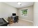 Bright bedroom featuring a computer desk, piano, and a window with a pleasant view at 2350 Derbyshire Rd, Maitland, FL 32751