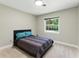 Bedroom featuring carpet, neutral walls, and a window that brightens the space at 2350 Derbyshire Rd, Maitland, FL 32751