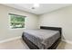 Bedroom featuring carpet, neutral walls, and a window that brightens the space at 2350 Derbyshire Rd, Maitland, FL 32751