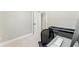 Bedroom featuring carpet, base trim, and an open door, along with a keyboard on a desk at 2350 Derbyshire Rd, Maitland, FL 32751