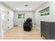 Bedroom featuring hardwood floors, modern lighting, and a massage chair at 2350 Derbyshire Rd, Maitland, FL 32751