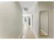 Bright hallway featuring wood floors, neutral walls, and a full-length mirror at 2350 Derbyshire Rd, Maitland, FL 32751