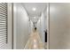 Long hallway with hardwood floors, recessed lighting and neutral paint at 2350 Derbyshire Rd, Maitland, FL 32751