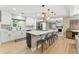 Bright open kitchen with island seating, stainless steel appliances, and modern pendant lighting at 2350 Derbyshire Rd, Maitland, FL 32751