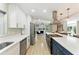 Stylish kitchen with white cabinetry, stainless steel appliances, and an open view to the living area at 2350 Derbyshire Rd, Maitland, FL 32751