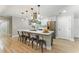 An open kitchen features an island with seating, modern appliances, and pendant lighting at 2350 Derbyshire Rd, Maitland, FL 32751