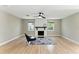 Bright living room with a decorative fireplace, hardwood floors, and contemporary design at 2350 Derbyshire Rd, Maitland, FL 32751