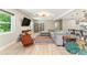 This open concept living room features hardwood floors and modern lighting at 2350 Derbyshire Rd, Maitland, FL 32751