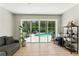 Bright living area boasts a seamless indoor-outdoor flow with views of the private pool at 2350 Derbyshire Rd, Maitland, FL 32751