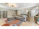Open-concept living room with kitchen view, hardwood floors, and modern lighting fixtures at 2350 Derbyshire Rd, Maitland, FL 32751