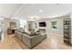 Spacious living room with recessed lighting, hardwood floors, and large sectional couch at 2350 Derbyshire Rd, Maitland, FL 32751