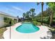 Inviting kidney-shaped pool surrounded by lush tropical landscaping and a spacious deck area at 2350 Derbyshire Rd, Maitland, FL 32751