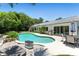 Backyard pool featuring a dining table and a barbeque grill at 2350 Derbyshire Rd, Maitland, FL 32751
