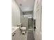 Compact bathroom with a shower featuring gray tile and modern fixtures at 2505 Osprey Creek Ct, Kissimmee, FL 34747