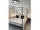 Bedroom featuring a four-poster bed, ceiling fan, and bedside tables with lamps at 2505 Osprey Creek Ct, Kissimmee, FL 34747