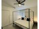 Bedroom featuring a four-poster bed, ceiling fan, and bedside tables with lamps at 2505 Osprey Creek Ct, Kissimmee, FL 34747
