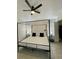 Sleek main bedroom with a modern four-poster bed, ceiling fan, and tiled floor at 2505 Osprey Creek Ct, Kissimmee, FL 34747