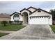 Charming single Gathering home featuring neutral paint, an arched doorway, and manicured landscaping at 2505 Osprey Creek Ct, Kissimmee, FL 34747
