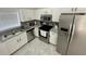 A stylish kitchen with stainless steel appliances, granite countertops, and white cabinets at 2505 Osprey Creek Ct, Kissimmee, FL 34747